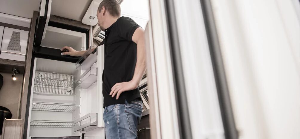 man looking at refrigerator