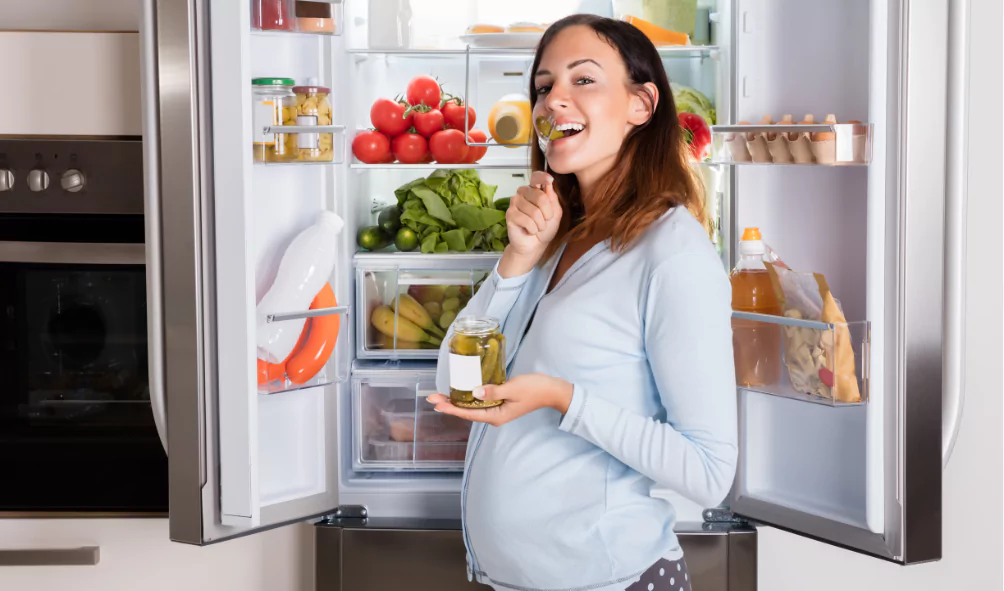 refrigerator repair pregnant woman checking fridge